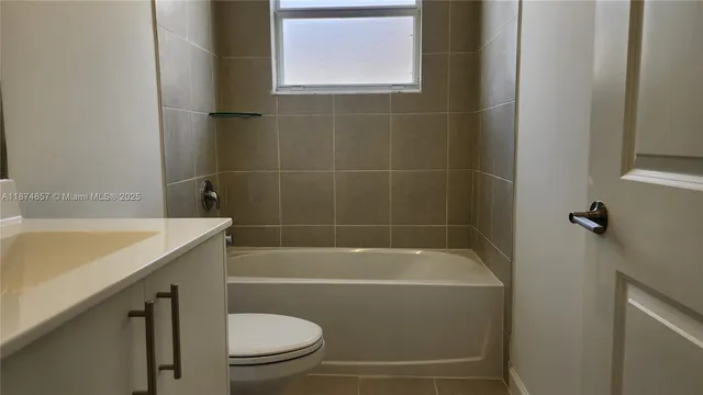 a bathroom with a bath tub a toilet and a sink