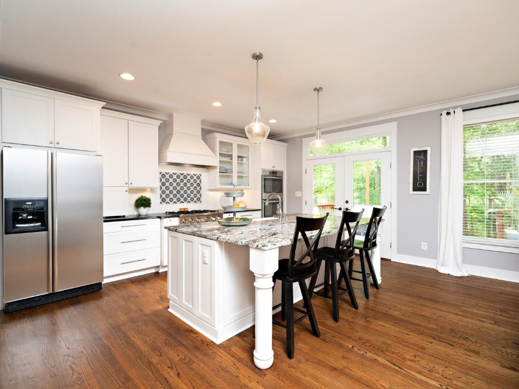 2516 Mt Vernon Church Road Raleigh, NC 27614 - Photo 18 of 58 a kitchen with stainless steel appliances a dining table chairs stove refrigerator and wooden floor