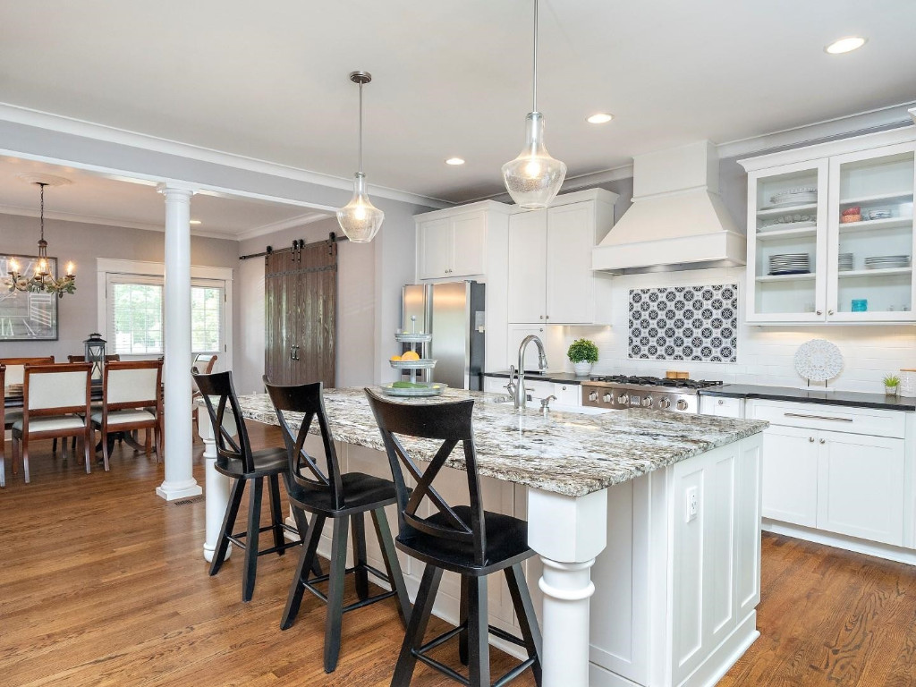 2516 Mt Vernon Church Road Raleigh, NC 27614 - Photo 19 of 58 a kitchen with kitchen island granite countertop a table chairs sink and cabinets