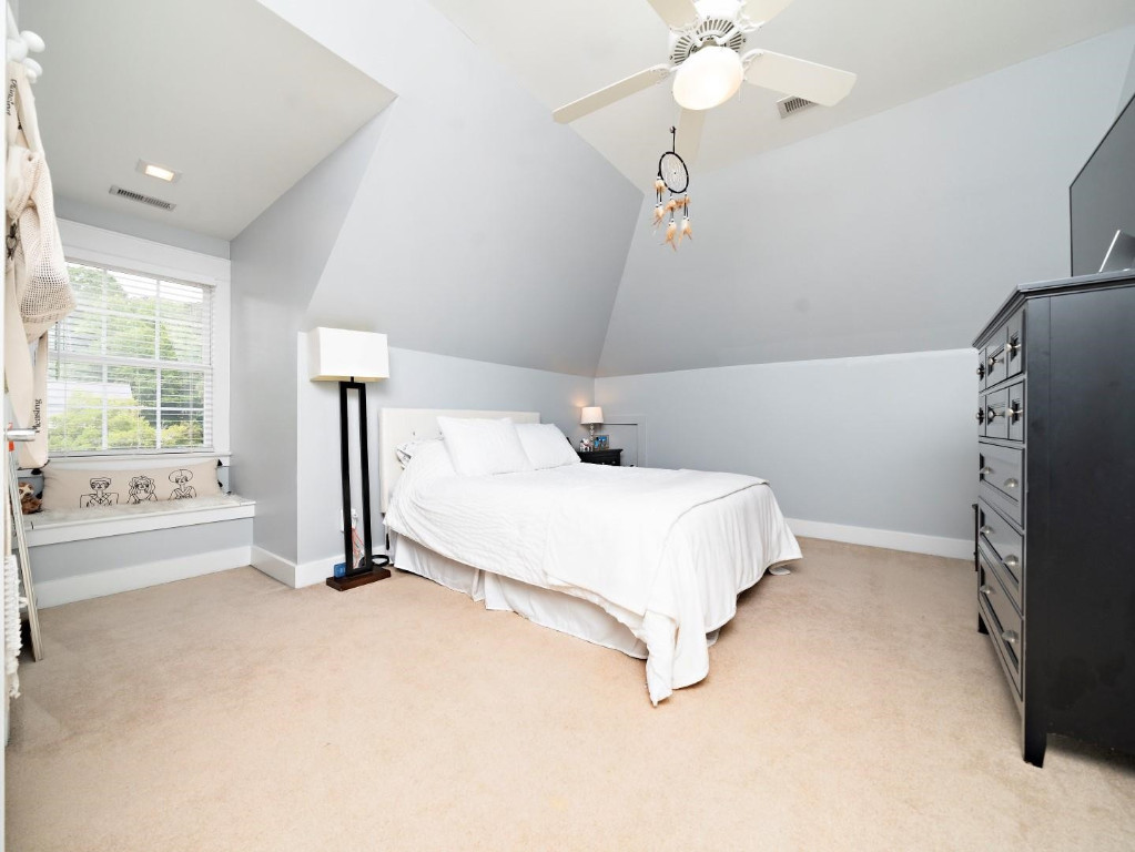 2516 Mt Vernon Church Road Raleigh, NC 27614 - Photo 35 of 58 a bedroom with a bed and a chandelier