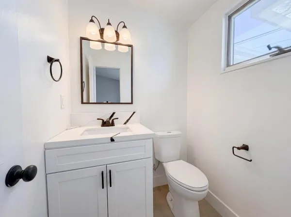 a bathroom with a toilet sink and mirror