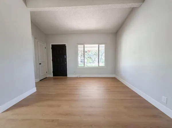 an empty room with windows and closet