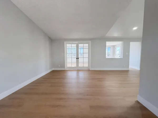 wooden floor in an empty room with a window