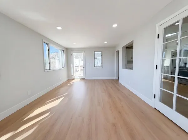wooden floor in an empty room with a window