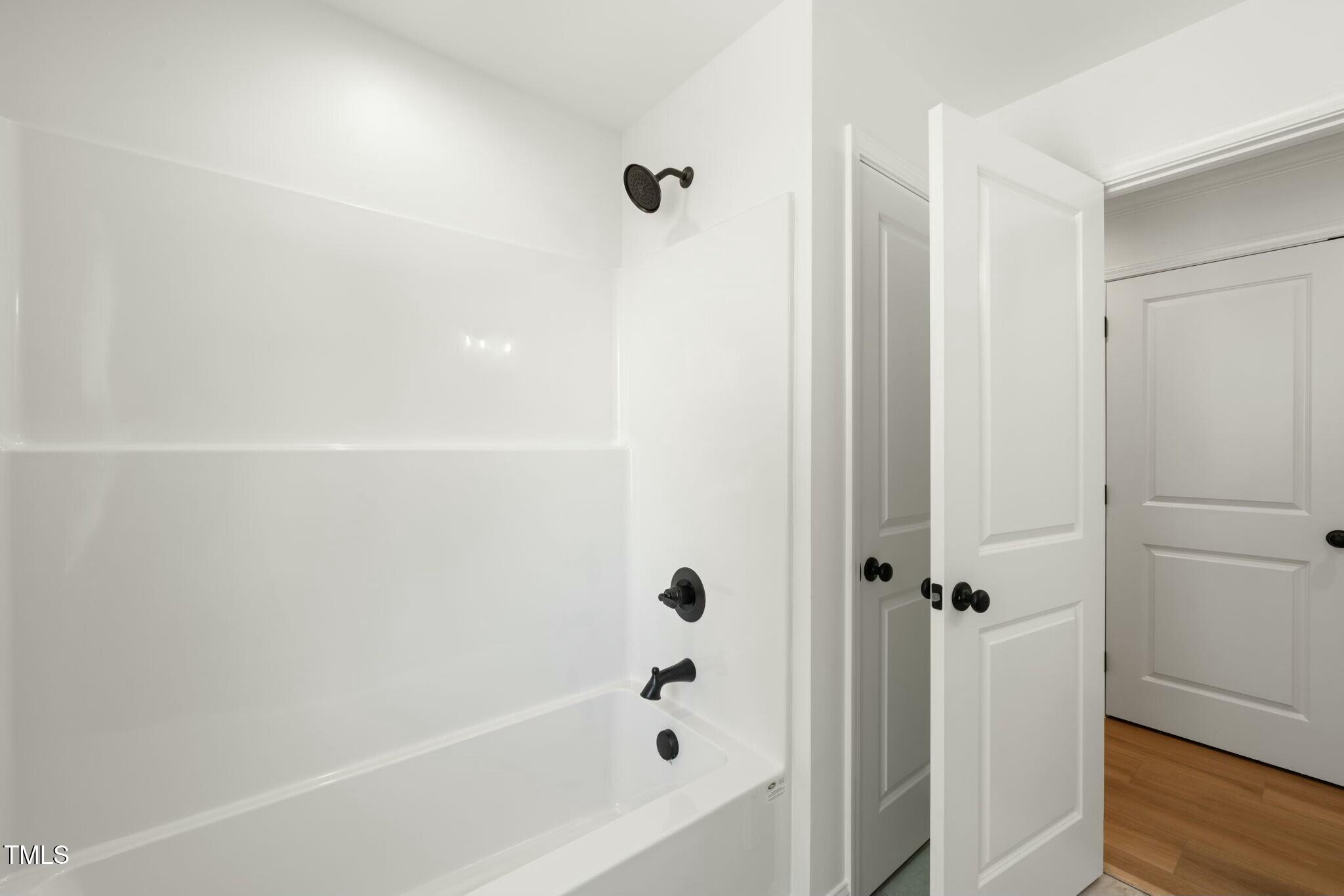 8917 Fowler Road Zebulon, NC 27597 - Photo 10 of 33 a bathroom with a bathtub