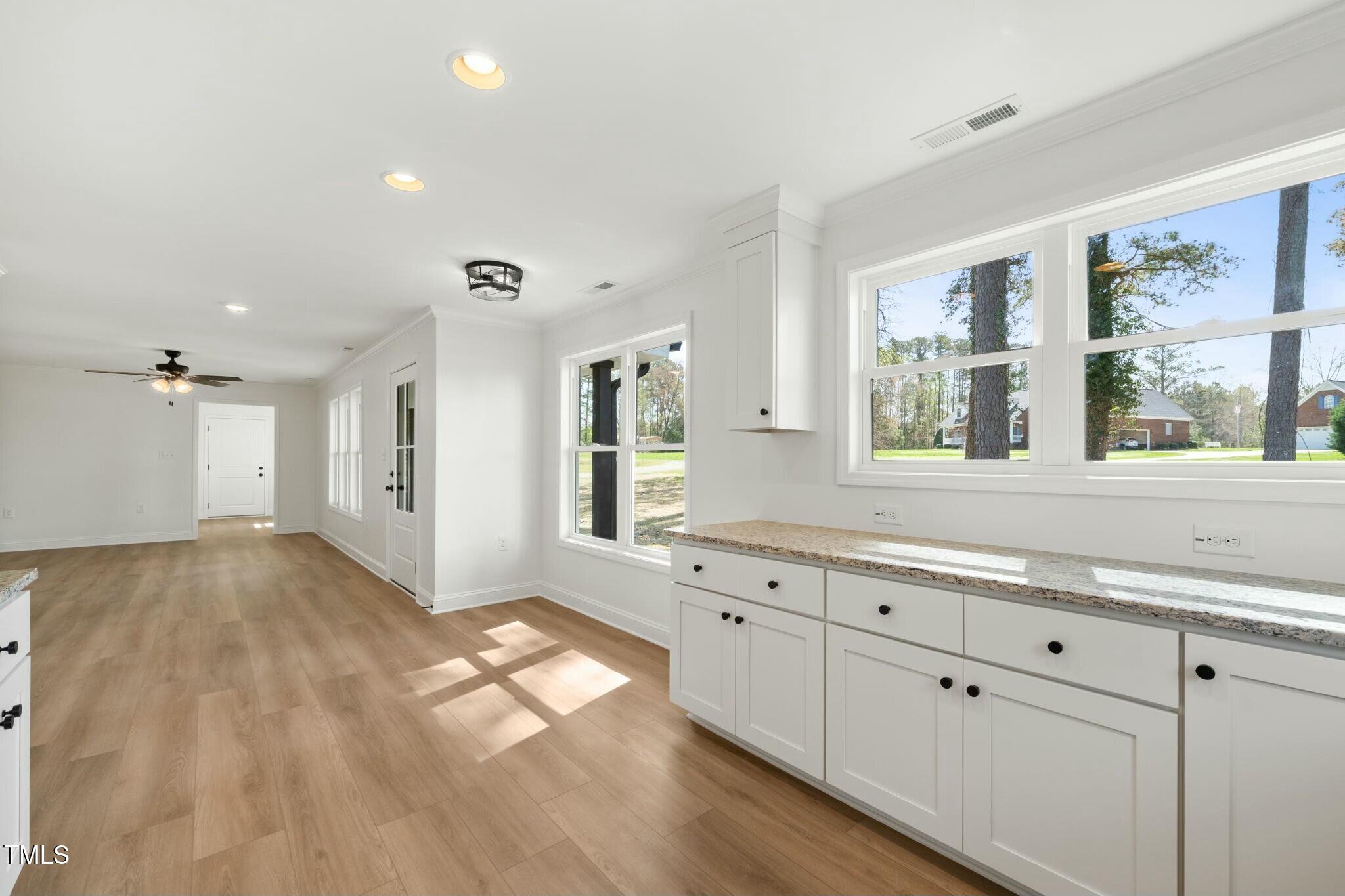 8917 Fowler Road Zebulon, NC 27597 - Photo 19 of 33 a view of a kitchen cabinets and a center island
