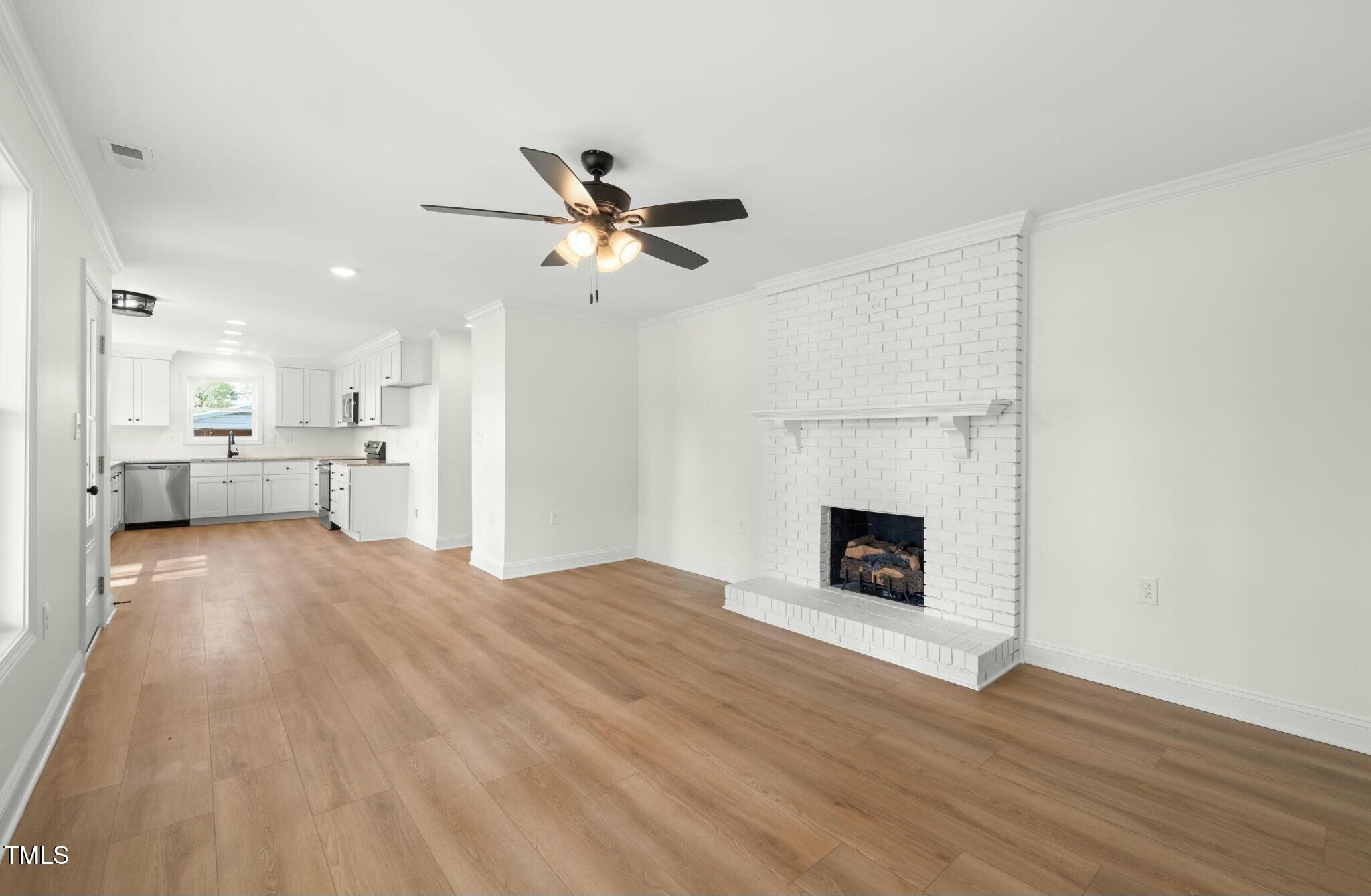 8917 Fowler Road Zebulon, NC 27597 - Photo 21 of 33 a view of a kitchen with furniture and a fireplace