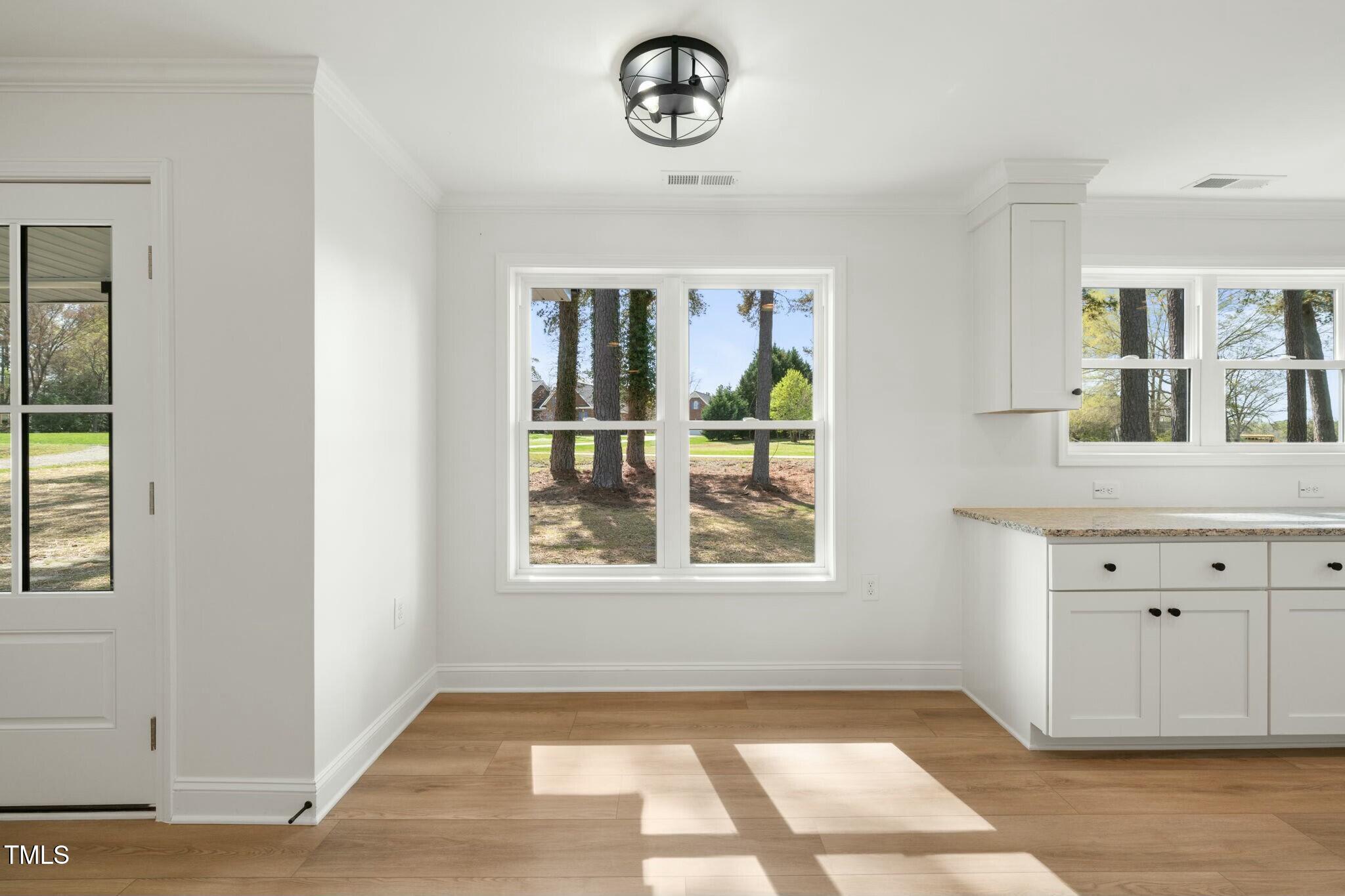 8917 Fowler Road Zebulon, NC 27597 - Photo 24 of 33 a view of an entryway with wooden floor and cabinet