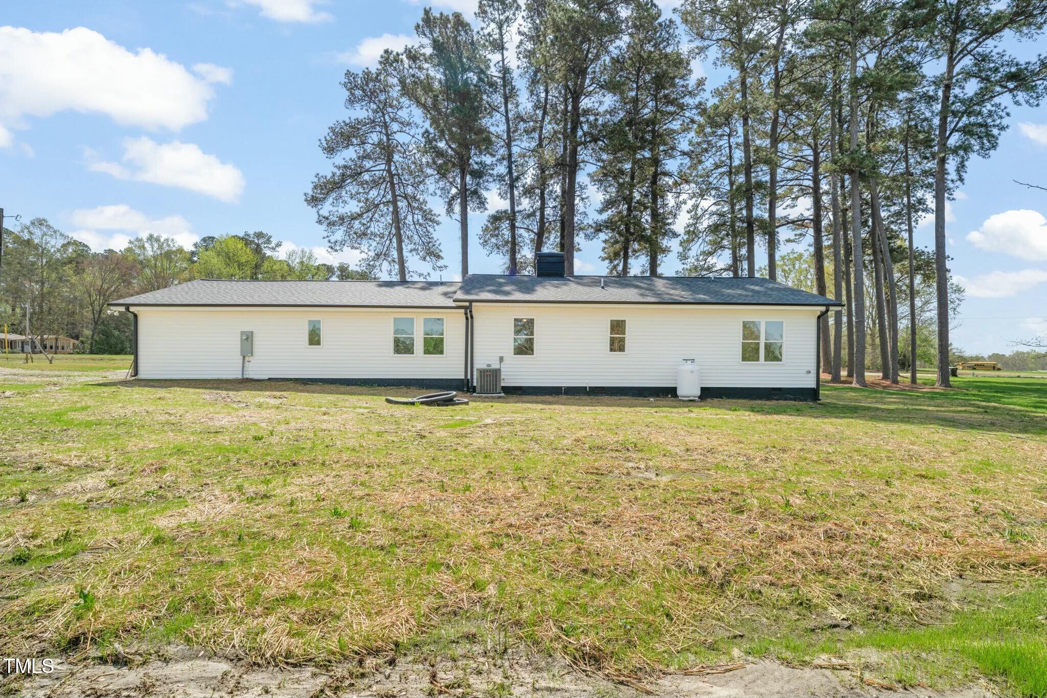 8917 Fowler Road Zebulon, NC 27597 - Photo 29 of 33 a view of a swimming pool with an outdoor seating and a yard