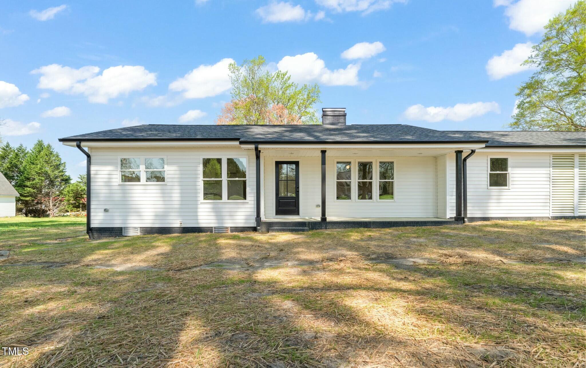 8917 Fowler Road Zebulon, NC 27597 - Photo 3 of 33 a view of a house with a big yard and potted plants