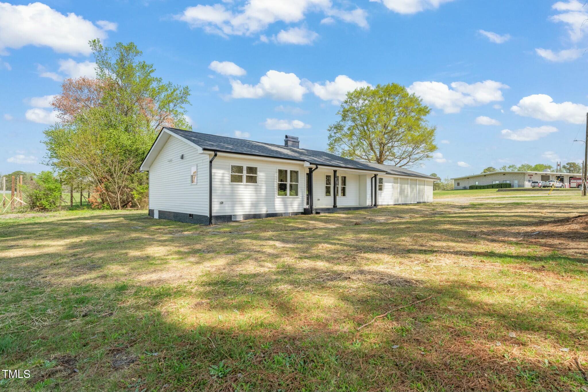 8917 Fowler Road Zebulon, NC 27597 - Photo 5 of 33 a view of a house with a swimming pool