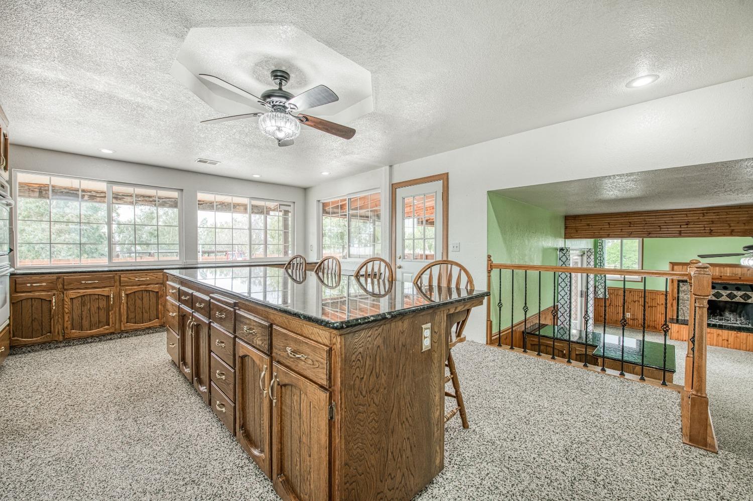 31334 Donald Avenue Madera, CA 93636 - Photo 12 of 38 a kitchen with stainless steel appliances granite countertop a stove a sink and a refrigerator