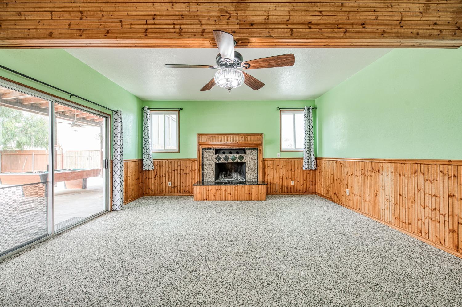 31334 Donald Avenue Madera, CA 93636 - Photo 13 of 38 a view of an empty room with a fireplace and a window