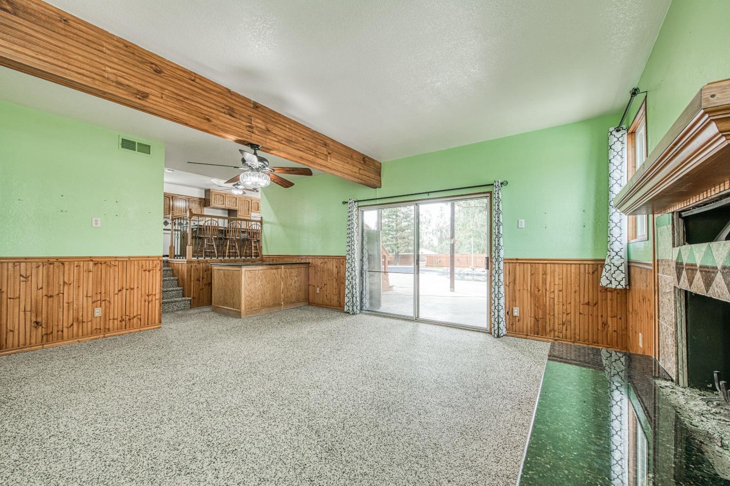 31334 Donald Avenue Madera, CA 93636 - Photo 15 of 38 a view of an empty room with floor to ceiling window and stairs