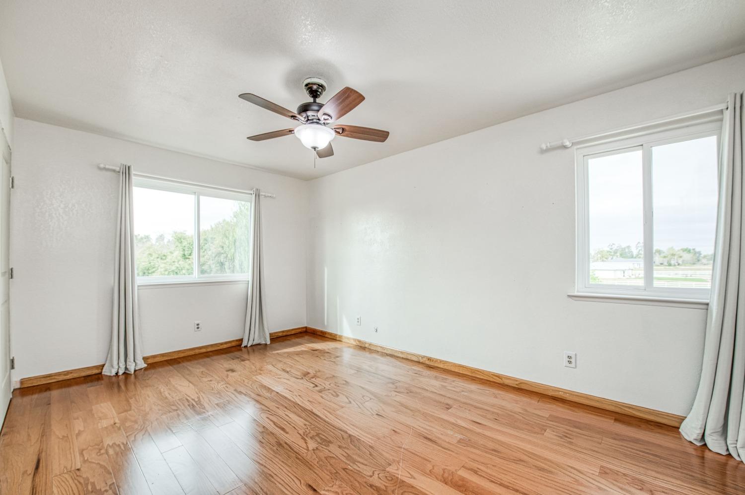 31334 Donald Avenue Madera, CA 93636 - Photo 18 of 38 a view of empty room with wooden floor and fan