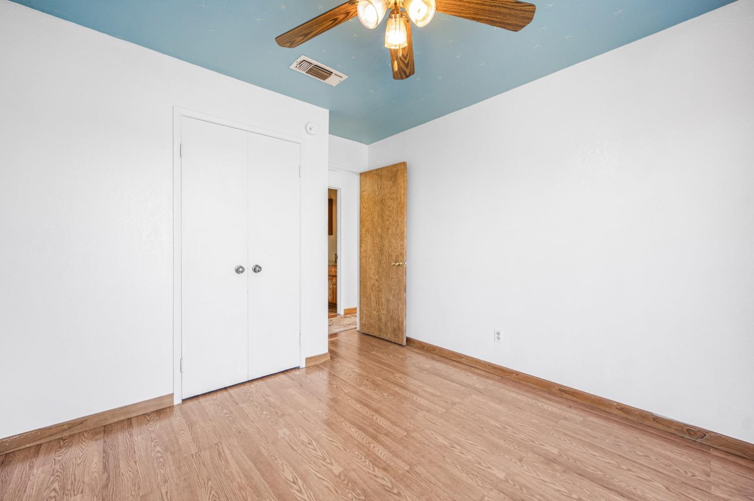 31334 Donald Avenue Madera, CA 93636 - Photo 20 of 38 an empty room with wooden floor fan and windows