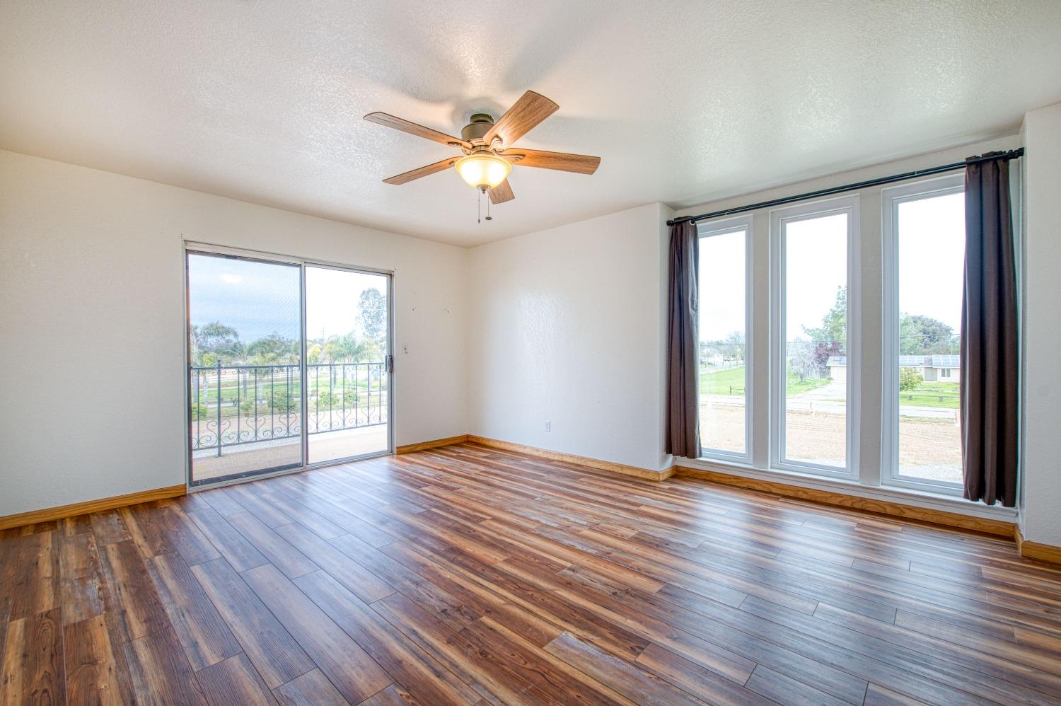 31334 Donald Avenue Madera, CA 93636 - Photo 22 of 38 a view of an empty room with wooden floor and a window