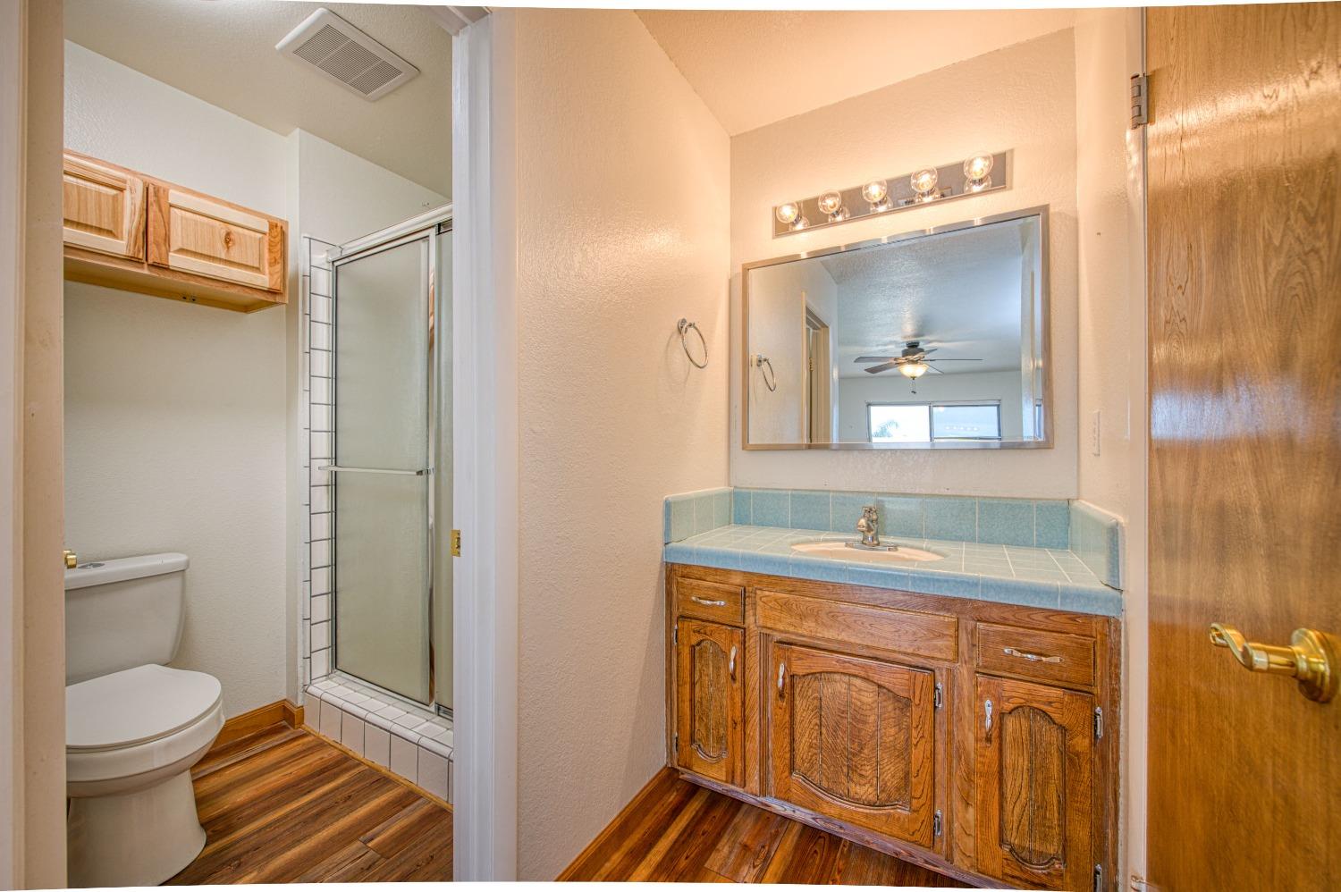 31334 Donald Avenue Madera, CA 93636 - Photo 24 of 38 a bathroom with a sink a toilet and a mirror