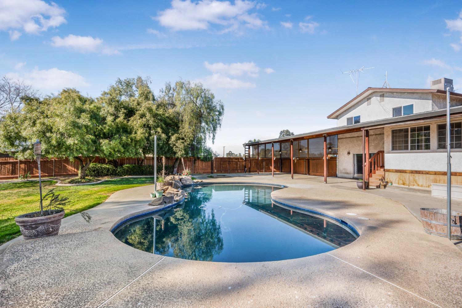 31334 Donald Avenue Madera, CA 93636 - Photo 26 of 38 a view of a house with swimming pool and sitting area