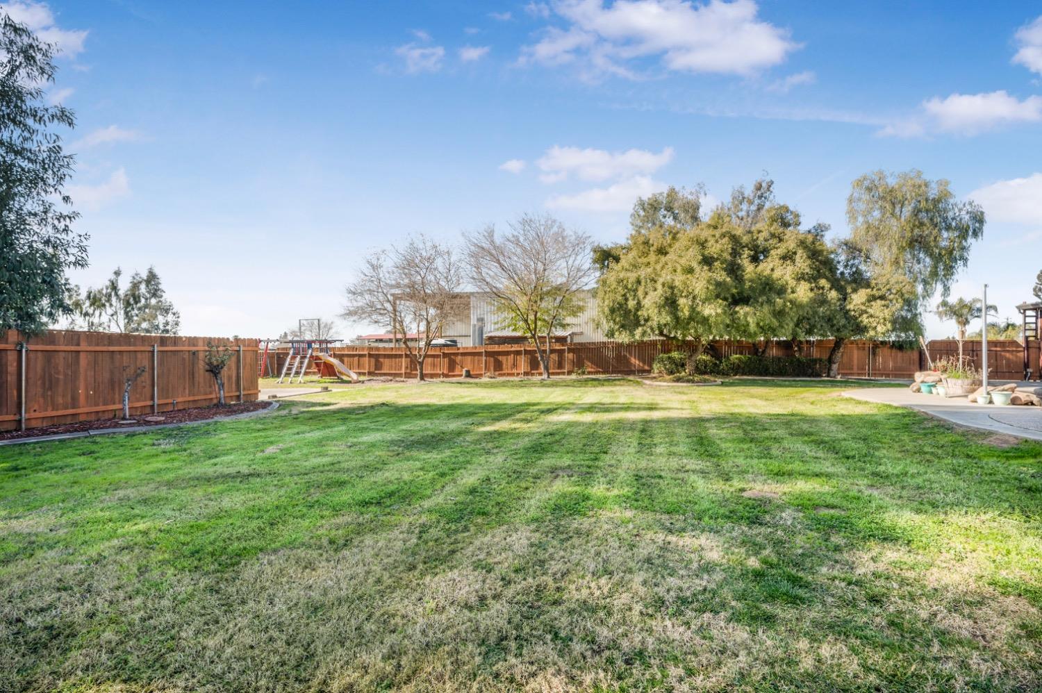 31334 Donald Avenue Madera, CA 93636 - Photo 28 of 38 a view of yard with swimming pool and green space