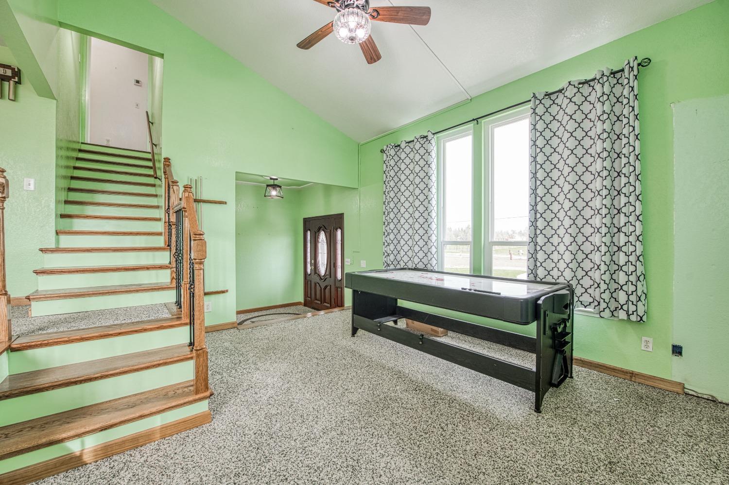 31334 Donald Avenue Madera, CA 93636 - Photo 3 of 38 a bedroom with a bed and a chandelier