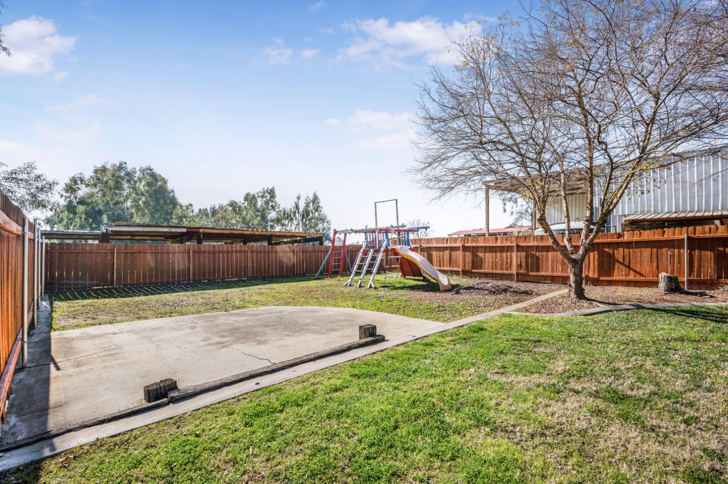31334 Donald Avenue Madera, CA 93636 - Photo 31 of 38 a view of a backyard with slide