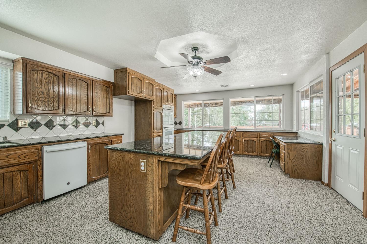 31334 Donald Avenue Madera, CA 93636 - Photo 7 of 38 a view of a dining room with furniture a chandelier and wooden floor