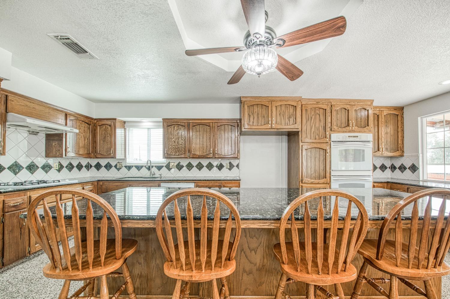 31334 Donald Avenue Madera, CA 93636 - Photo 9 of 38 a view of a dining room with furniture a chandelier and wooden floor
