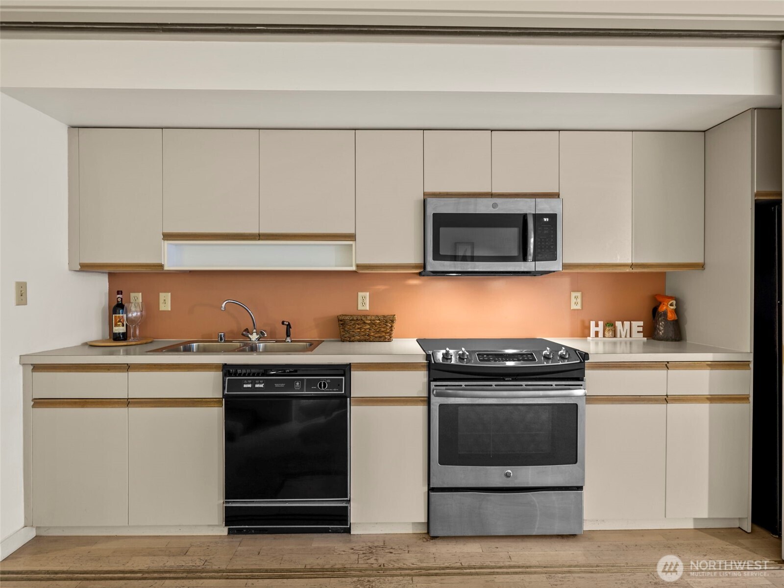 98 Union Street, Unit 610 Seattle, WA 98101 - Photo 14 of 33 a kitchen with granite countertop white cabinets and stainless steel appliances