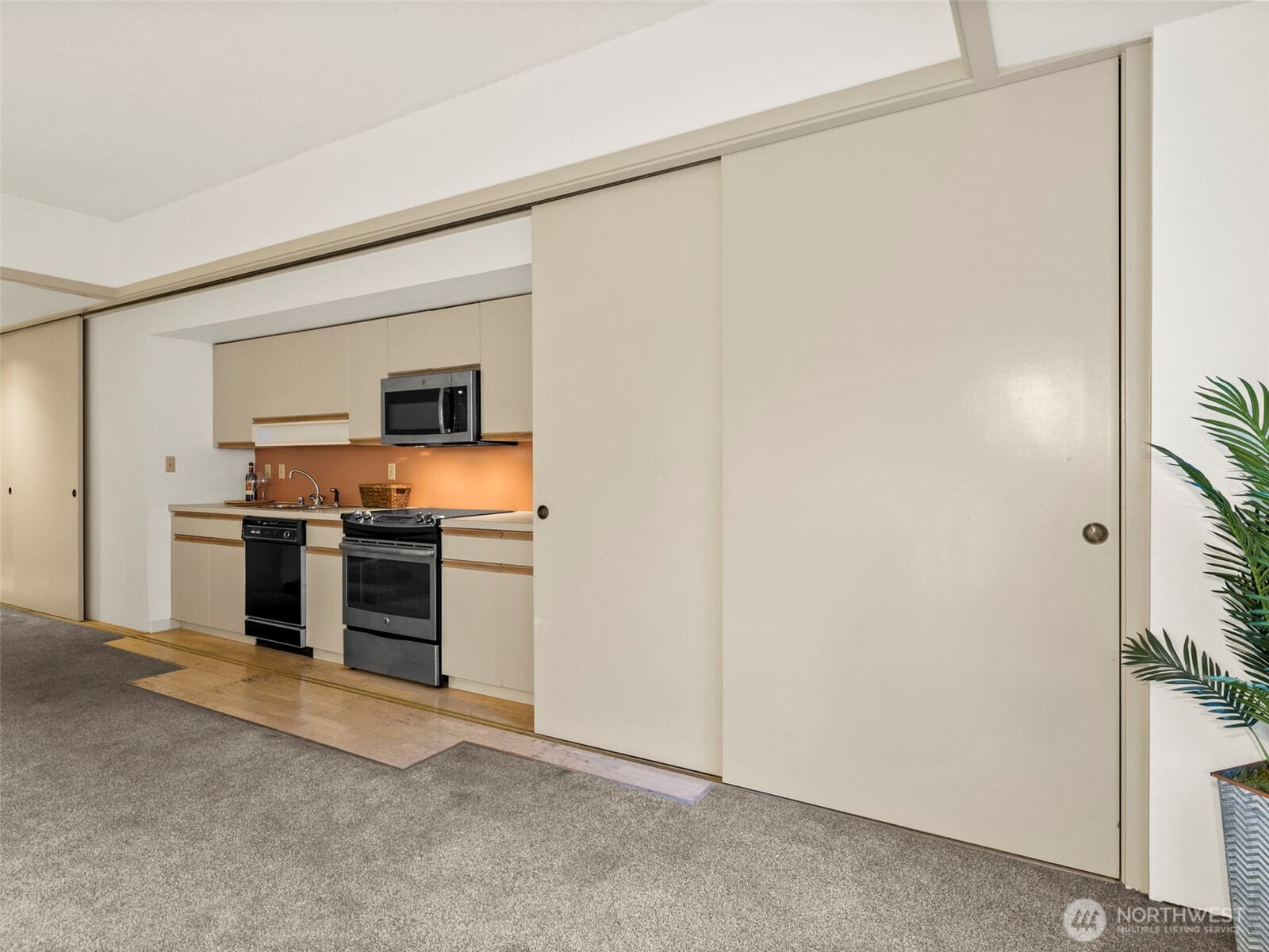 98 Union Street, Unit 610 Seattle, WA 98101 - Photo 16 of 33 a kitchen with stainless steel appliances a refrigerator and a stove top oven