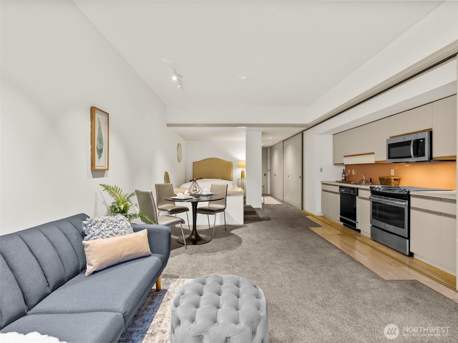 98 Union Street, Unit 610 Seattle, WA 98101 - Photo 17 of 33 a living room with furniture and a flat screen tv