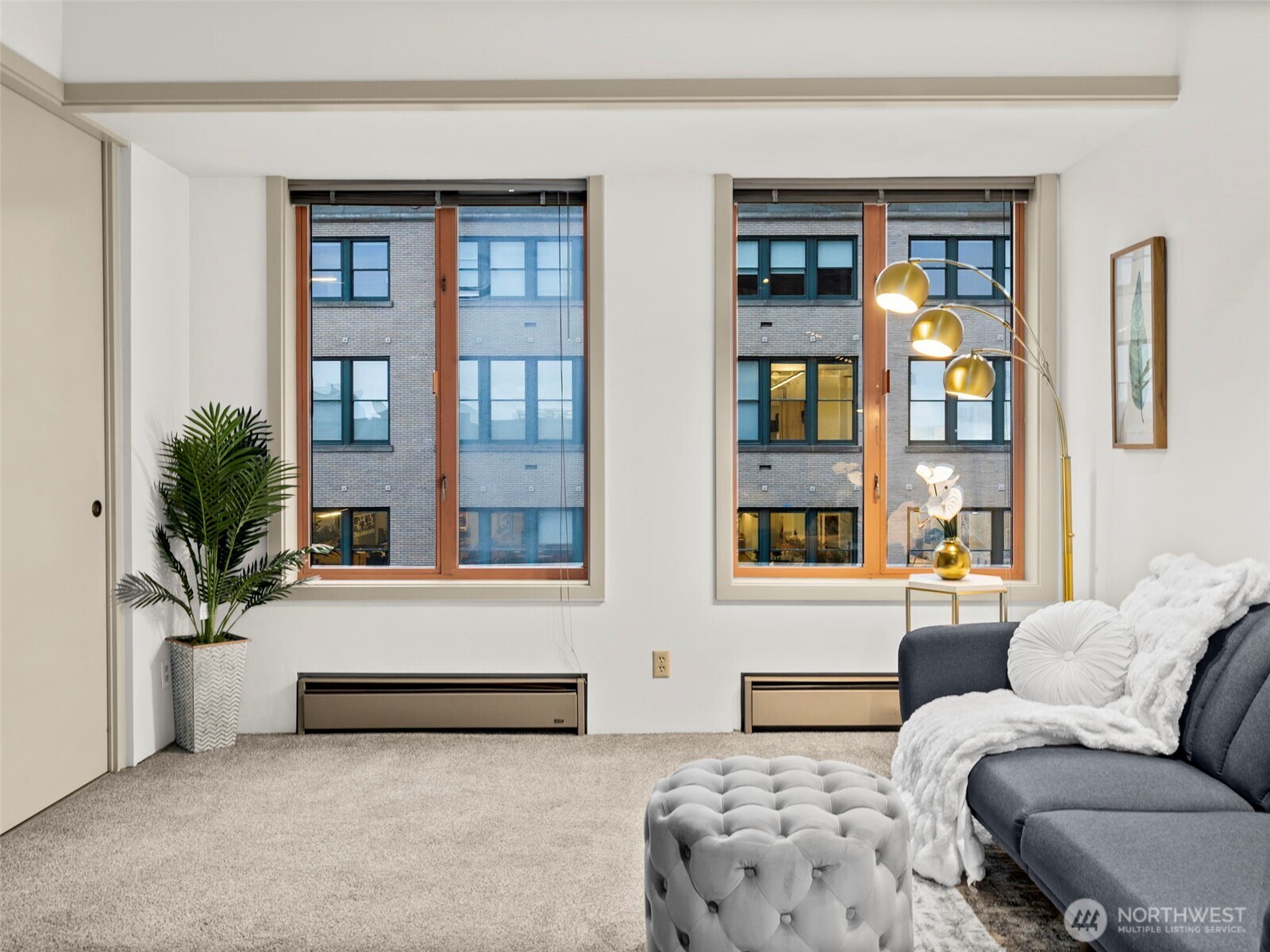 98 Union Street, Unit 610 Seattle, WA 98101 - Photo 21 of 33 a living room with furniture and a potted plant
