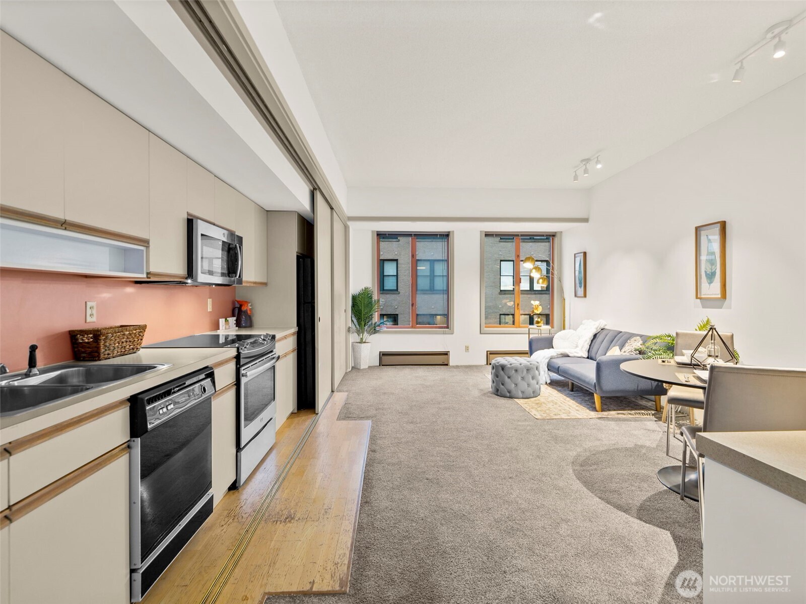 98 Union Street, Unit 610 Seattle, WA 98101 - Photo 24 of 33 a large living room with stainless steel appliances granite countertop lots of counter top space