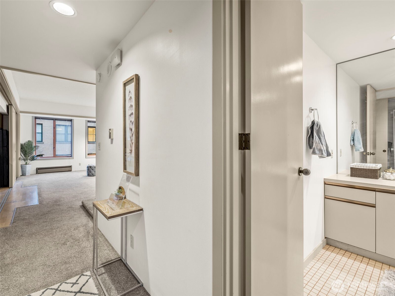 98 Union Street, Unit 610 Seattle, WA 98101 - Photo 7 of 33 a bathroom with a sink and a mirror