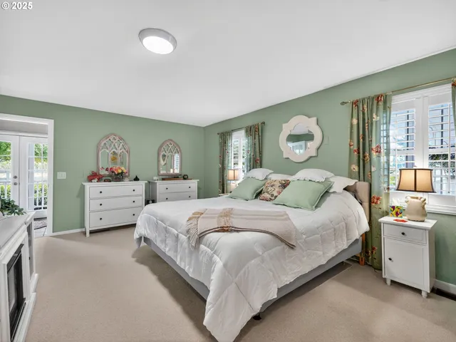 a bedroom with a bed and a large window