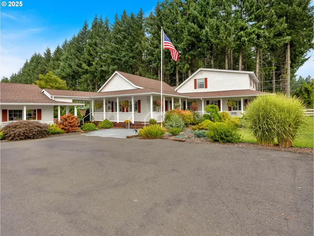 a front view of a house with a yard and potted plants