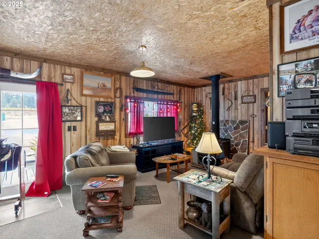 a living room with furniture a flat screen tv and gym equipment