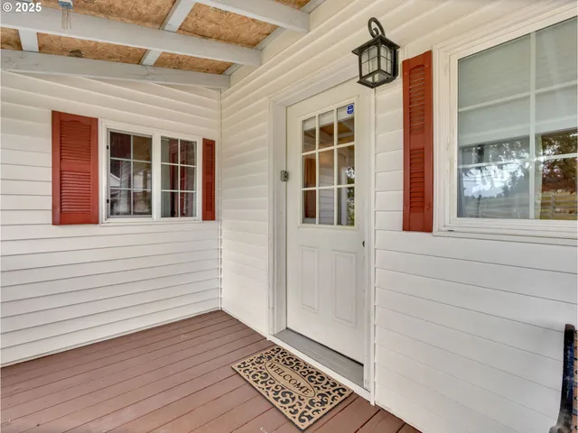 a living room with furniture and a refrigerator