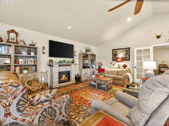 a living room with furniture a fireplace and a flat screen tv