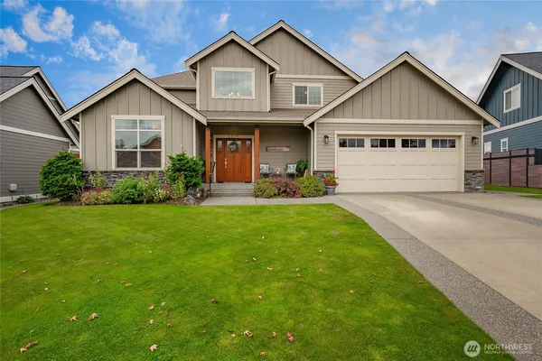 a front view of a house with a yard and porch