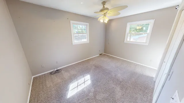 a view of room with window and ceiling fan