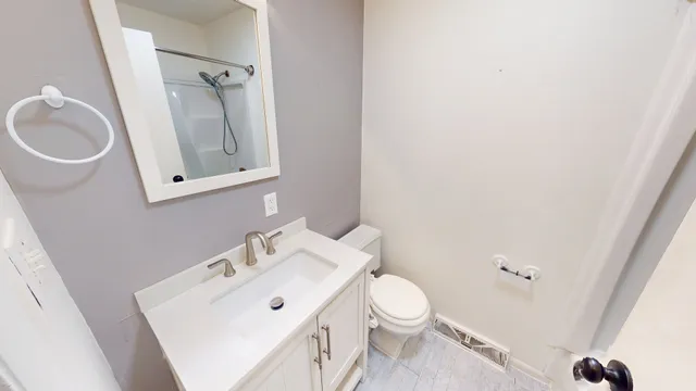 a white toilet sitting next to a bathroom sink