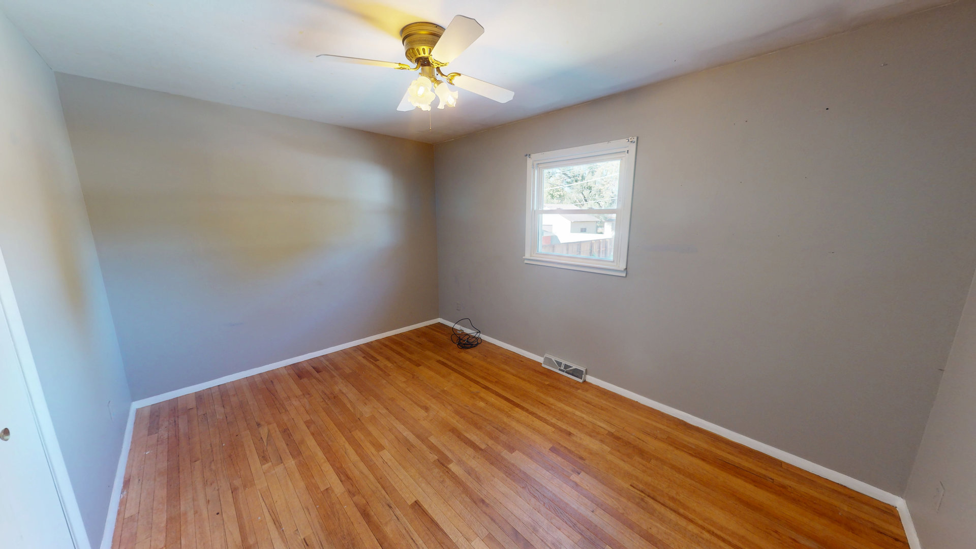102 West Douglas Street St. Joseph, IL 61873 - Photo 22 of 27 a view of a room with a wooden floor and a window
