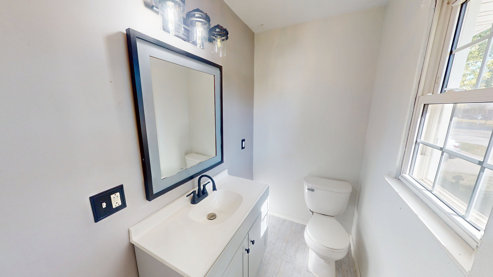 102 West Douglas Street St. Joseph, IL 61873 - Photo 24 of 27 a bathroom with a toilet sink and mirror