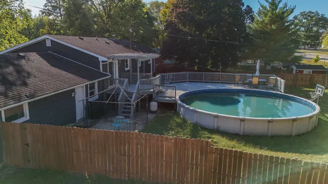 a view of house with swimming pool and sitting area