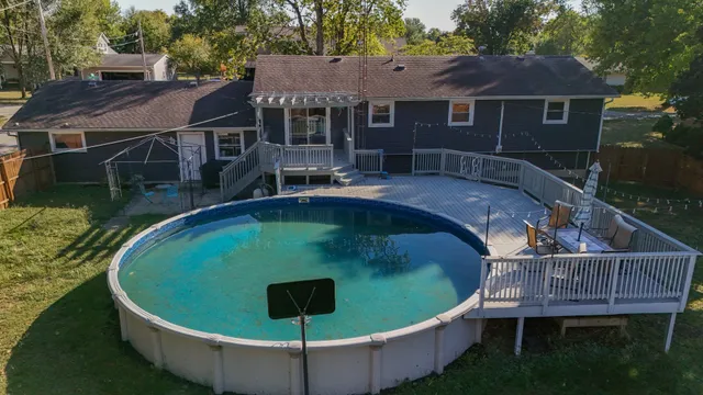 a view of a house with a yard and sitting area