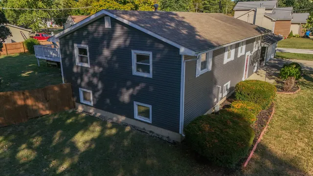 a aerial view of a house with a yard