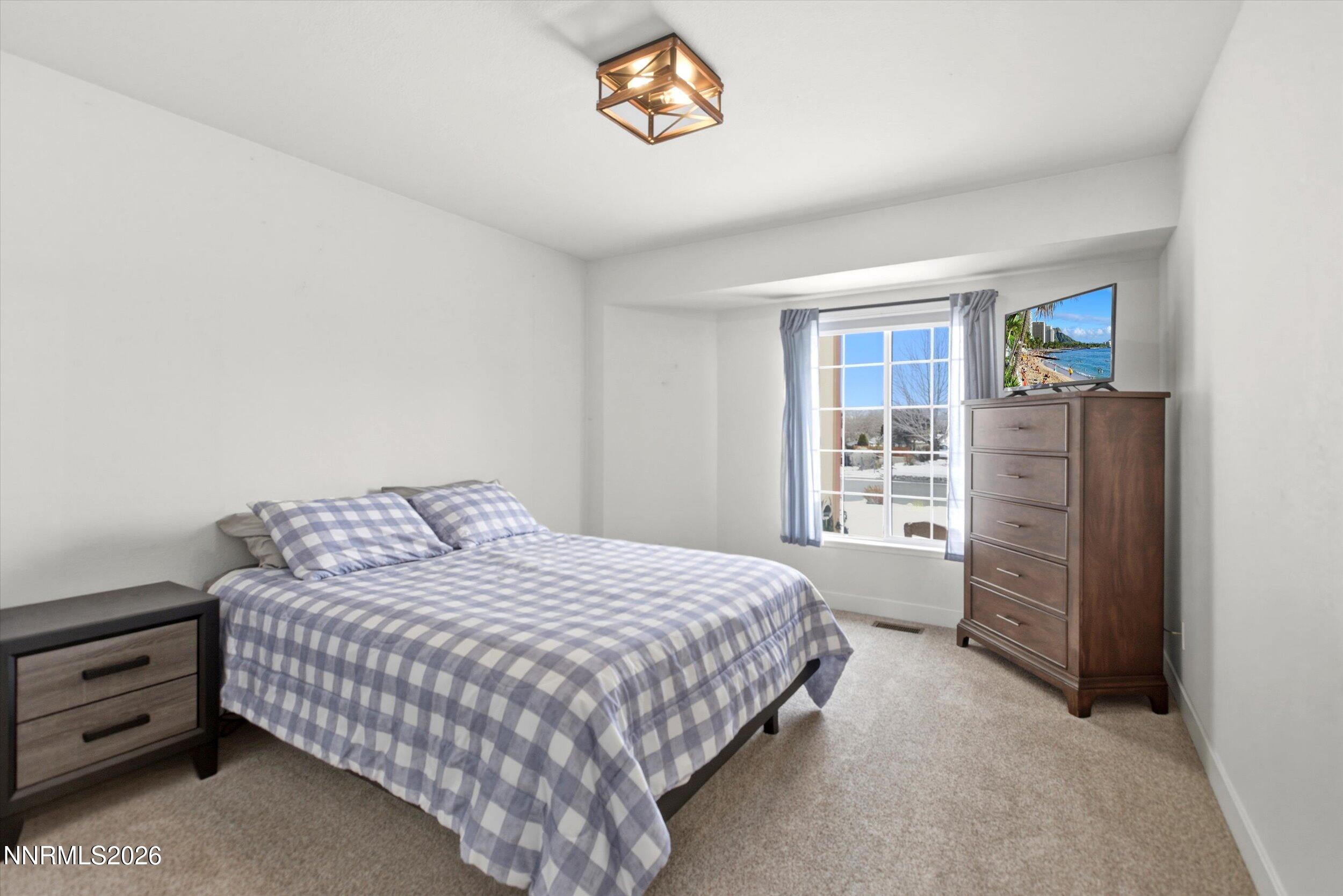 435 Kathy Terrace Sparks, NV 89436 - Photo 16 of 49 a bedroom with a bed and a window