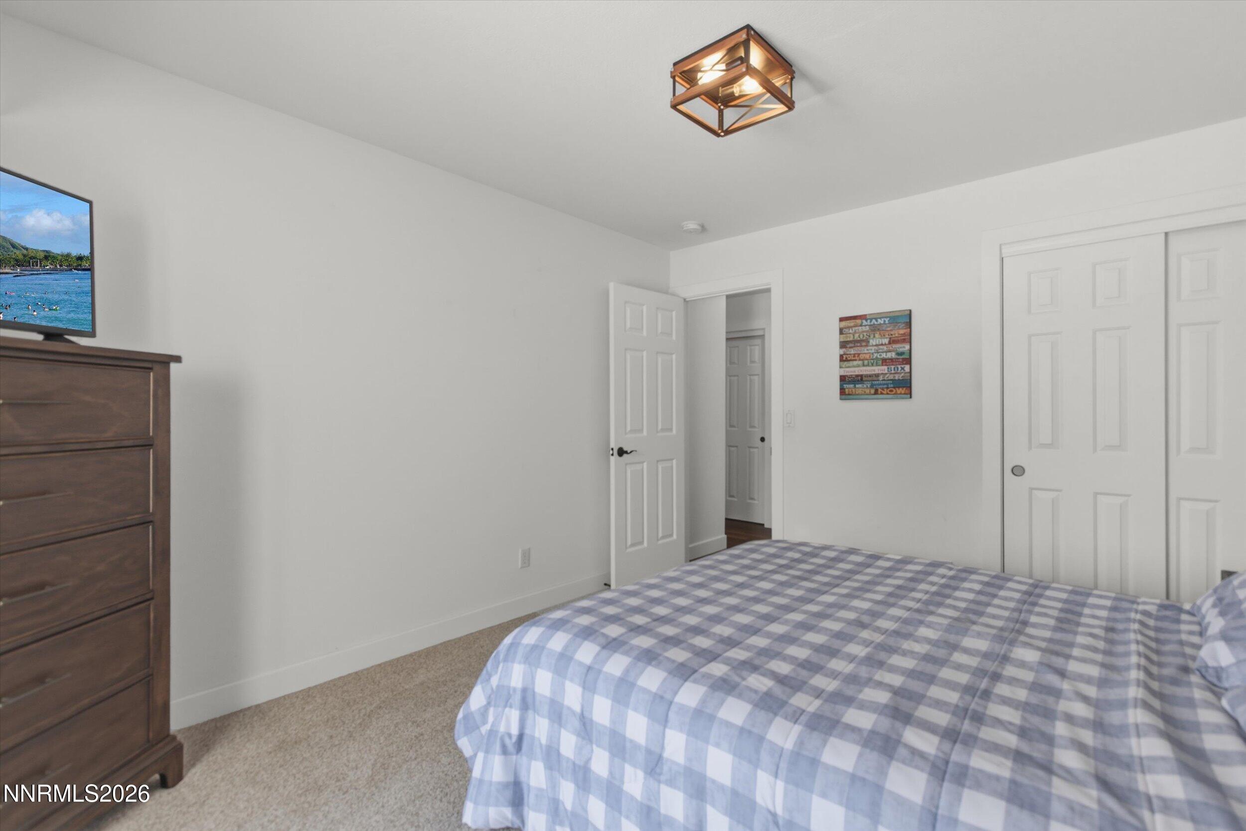 435 Kathy Terrace Sparks, NV 89436 - Photo 17 of 49 a bedroom with a bed and a table