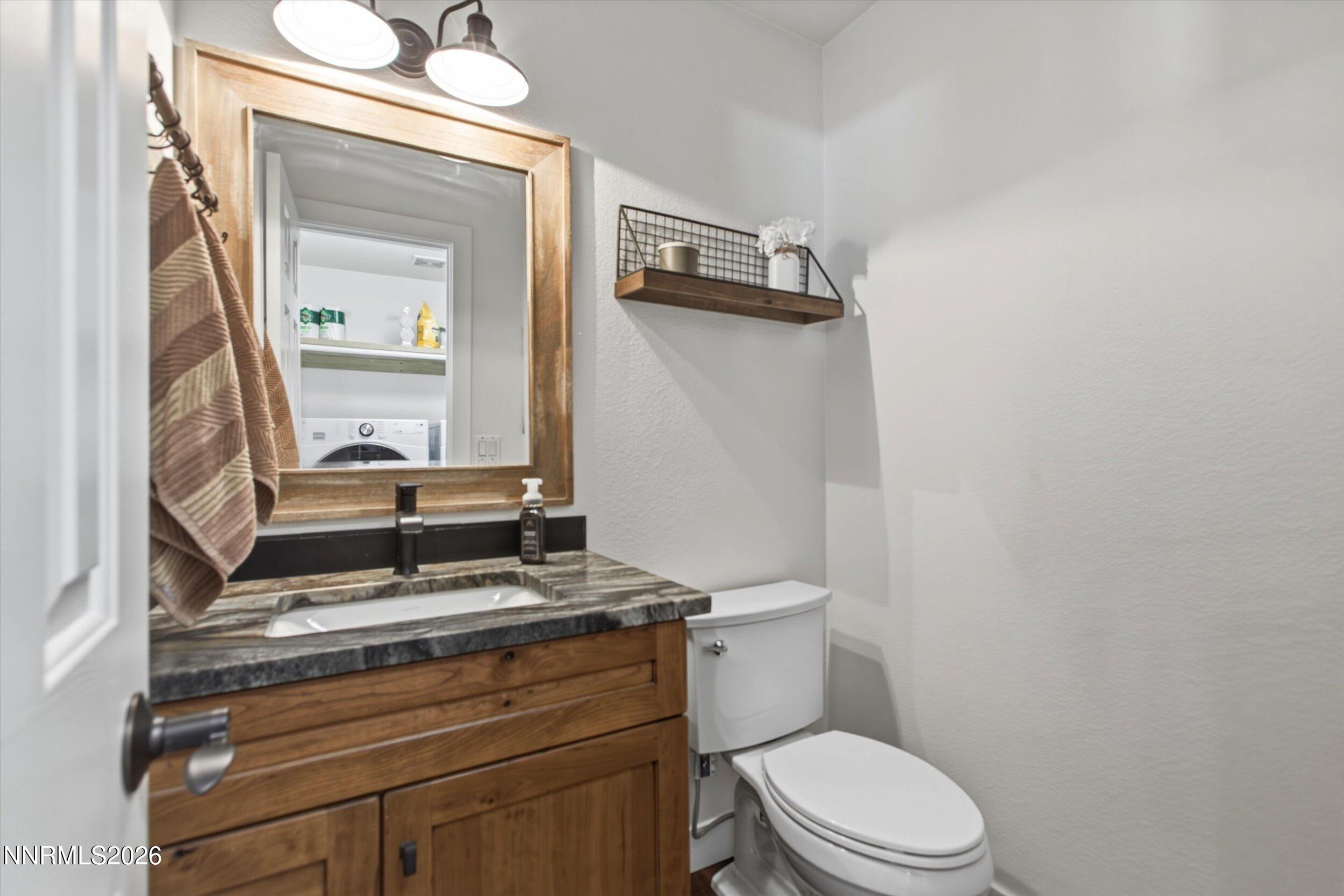 435 Kathy Terrace Sparks, NV 89436 - Photo 20 of 49 a bathroom with a toilet a sink and mirror